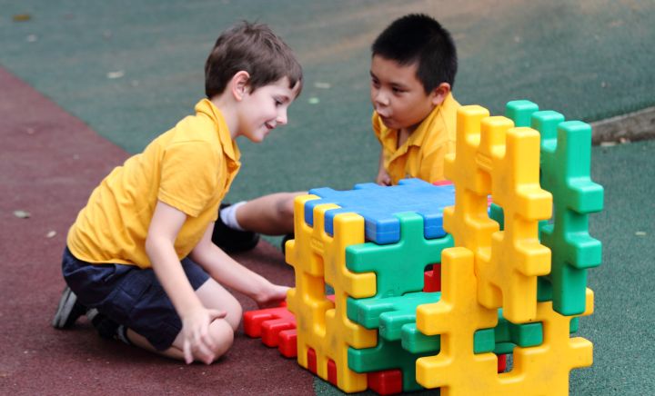 Students play with puzzle blocks in playground at Western Sydney School